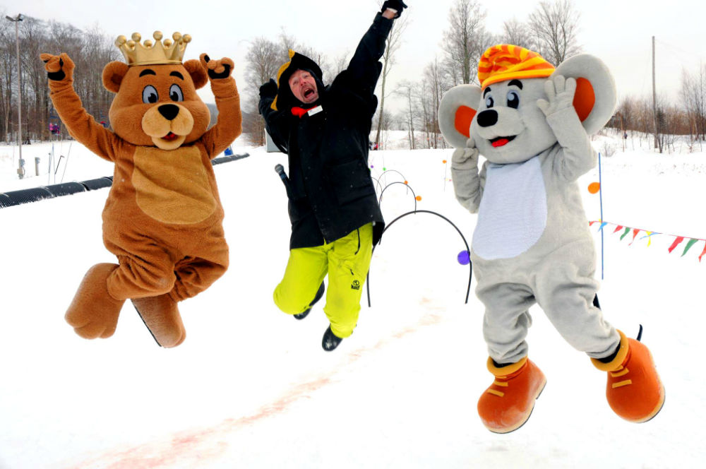 A mascot family with two mascot jumping into the air