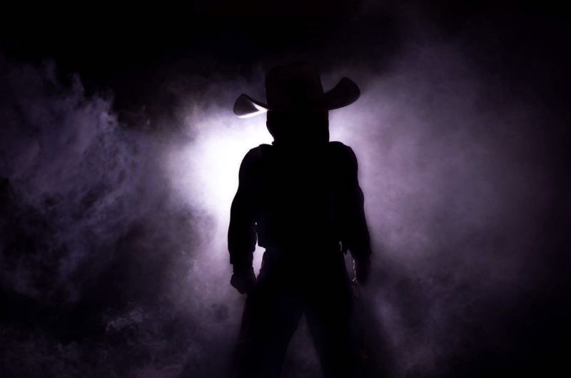 A silhouette of a cowboy mascot