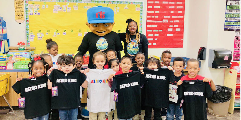 Astro Kidd mascot with local school children