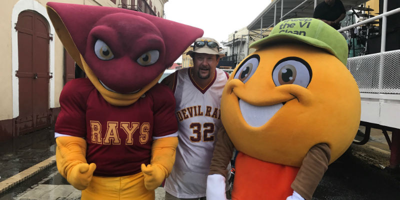 Two sports mascots with a fan