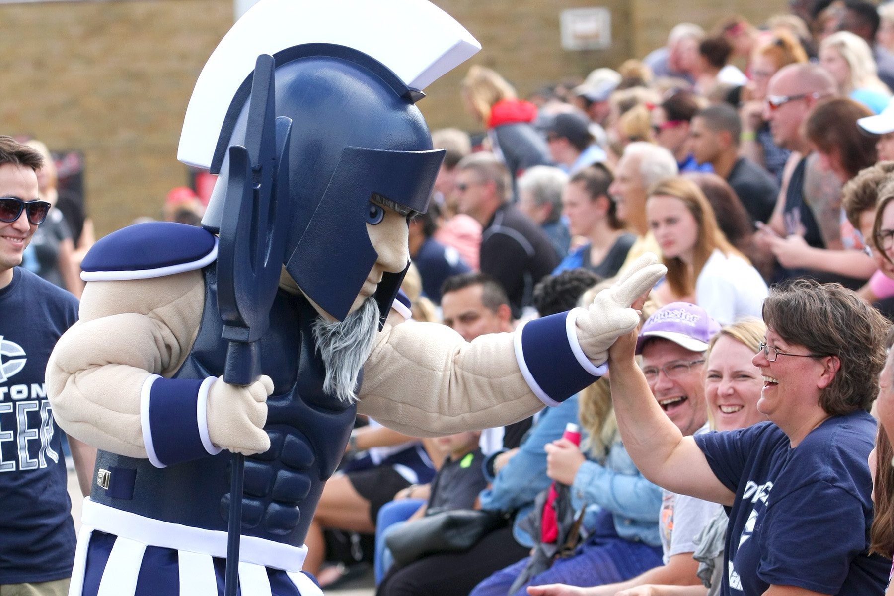 Iowa Central Community College Triton mascot high-diving a fan