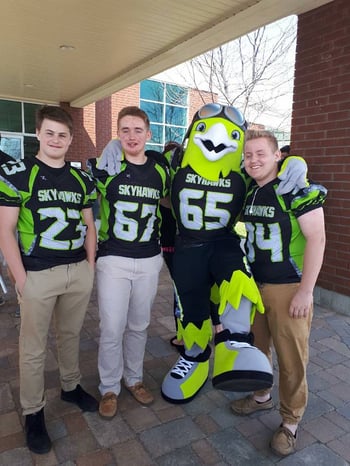 Rocky the Skyhawk mascot with team players