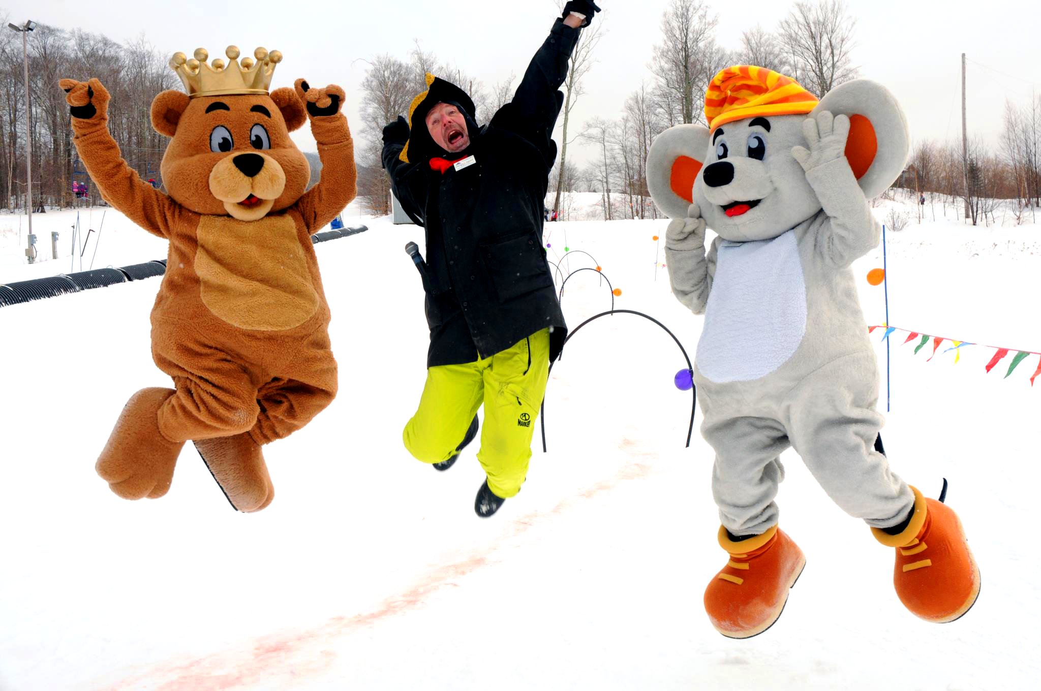 Two mascots jumping in the snow