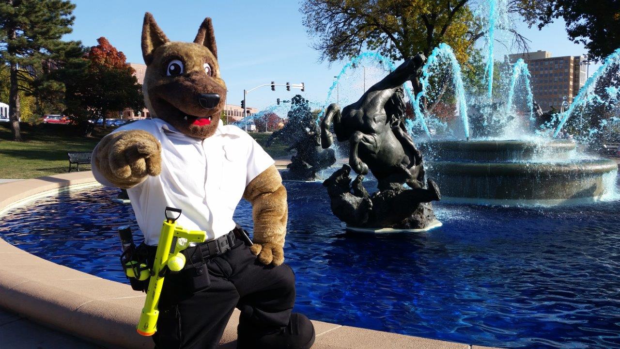 Ruger the Watchdog mascot standing by a fountain