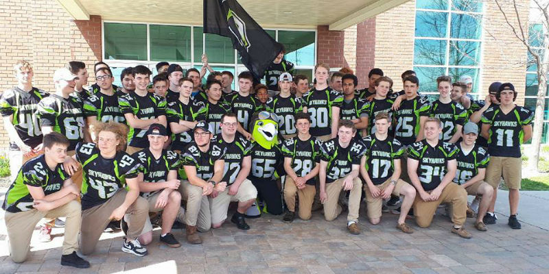 No Limits Football club mascot, Rocky the Skyhawk, with entire team 